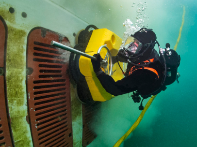 Commercial diver cleaning underwater structure